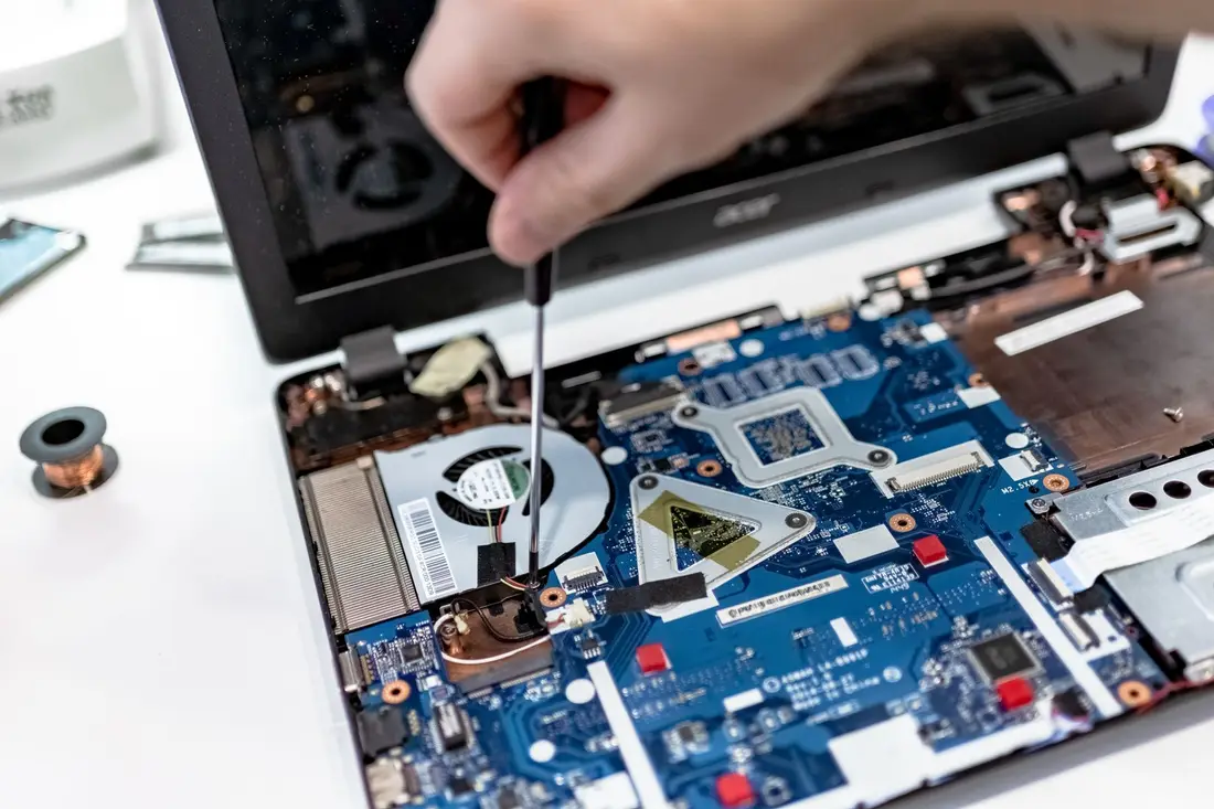 Laptop motherboard being repaired