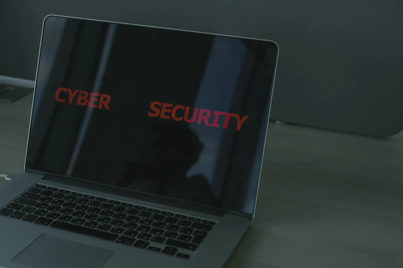 A laptop screen showing the words cyber security