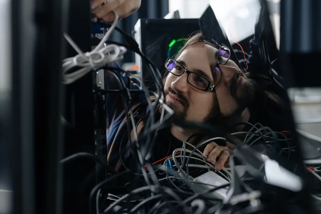 IT technician organizing cables at a workstation