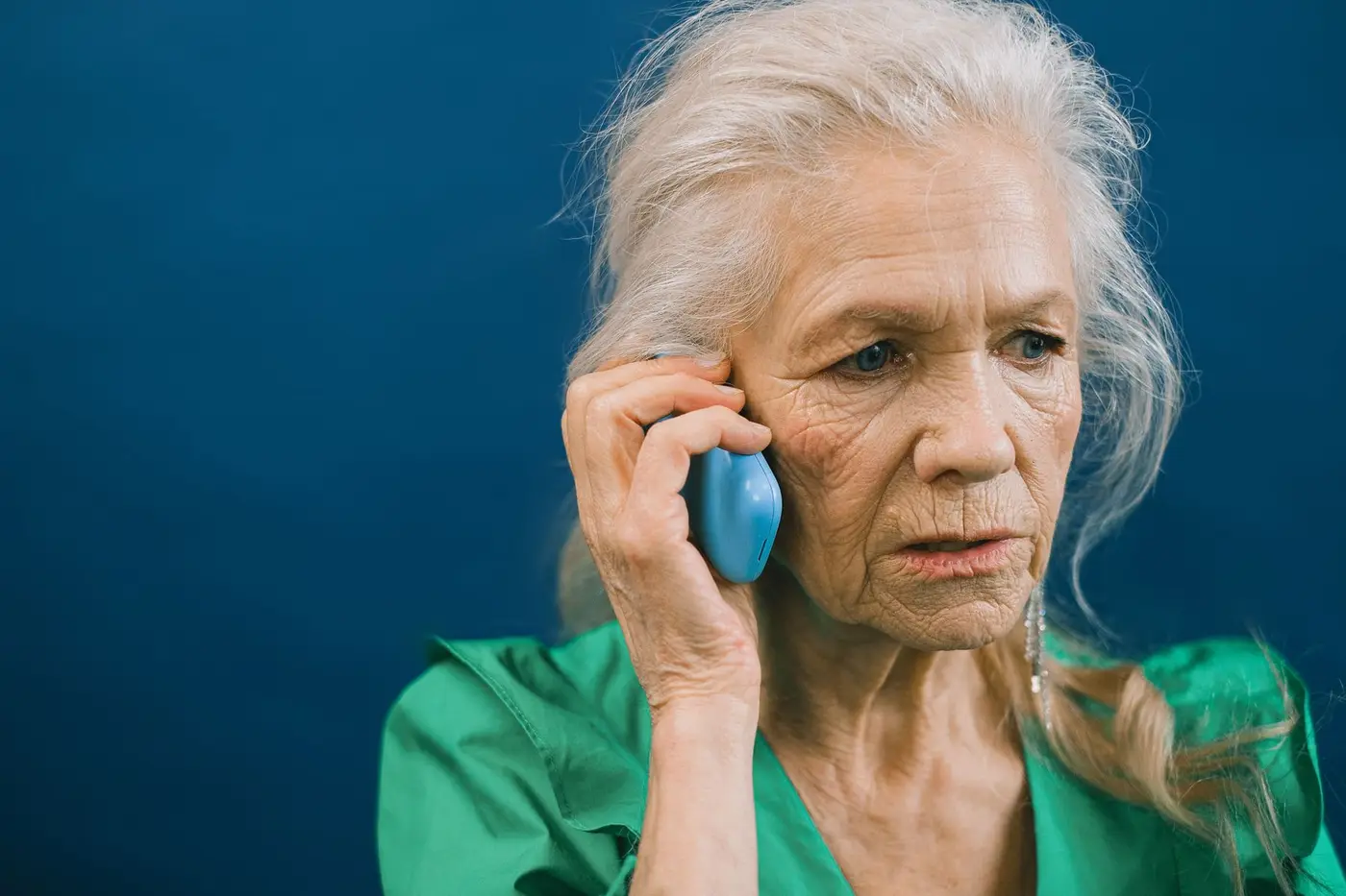 A woman on a phone call looking concerned